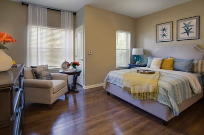 Cozy resident room with a bed and seating area