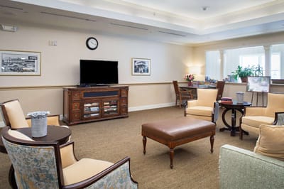 Bright common area with seating and a television.