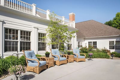 Outdoor seating area with chairs and landscaping