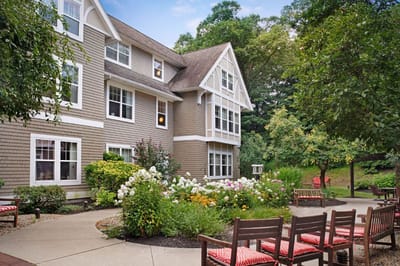 Building exterior with landscaped garden and seating area