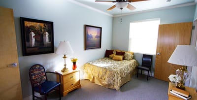 Cozy private resident room with bed and decor