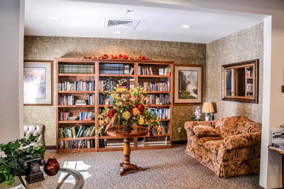 A cozy library area with bookshelves and seating