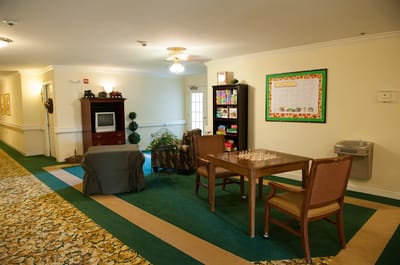 Common area with seating and games in a senior living facility