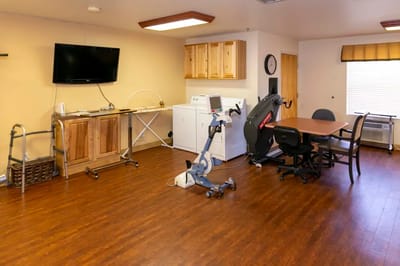 A common area with exercise equipment and seating