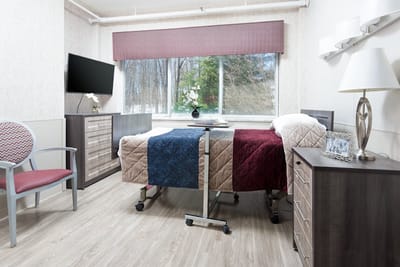 Twin beds in a shared resident room with modern decor