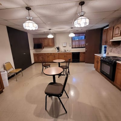 Bright, spacious common area with kitchen and tables