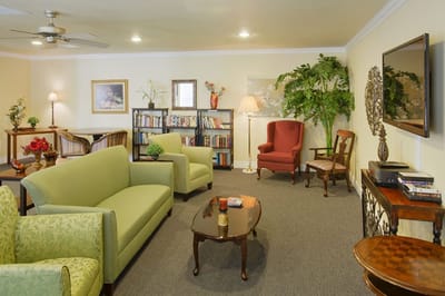 Cozy common area with seating and bookshelf