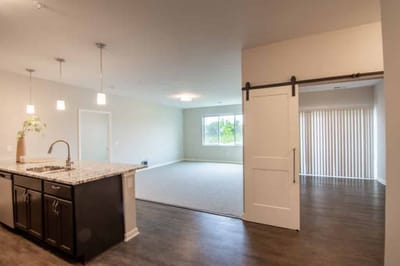 Modern interior space with kitchen and natural light.