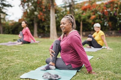 Residents participating in a yoga class outdoors.