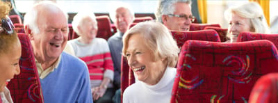 Seniors enjoying a fun outing on a bus