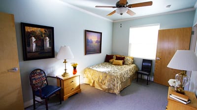 Cozy resident room with bed and decor.