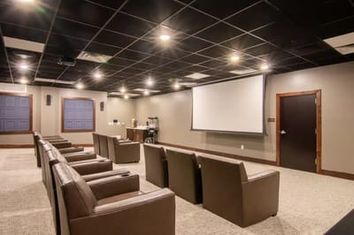 Home theater seating area with a projector screen