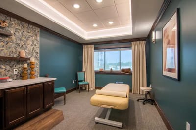 Therapy room with massage table and calming decor.