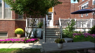 Outdoor seating area with flowers and greenery