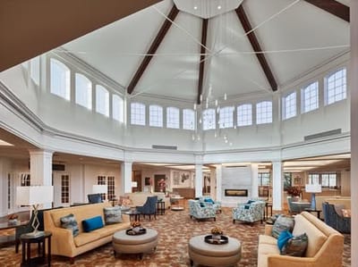 Interior view of a spacious lounge area with sofas and chairs