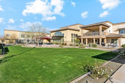 Exterior view of The Oaks by Senior Lifestyles with lawns and gardens