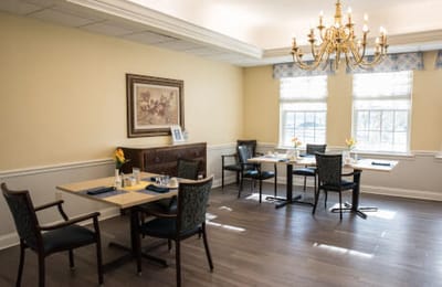 Dining room in a senior living facility with set tables