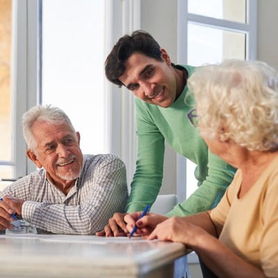 Residents and staff engaged in a joyful conversation