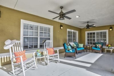 Outdoor seating area with colorful cushions and plants