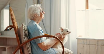 Resident with a small dog in a cozy interior