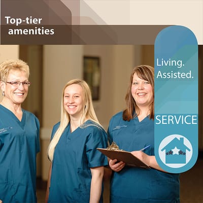 Three staff members posing in blue scrubs