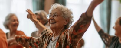 Residents enjoying a group activity with arms raised