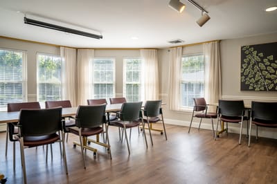 Bright common area with seating and large windows