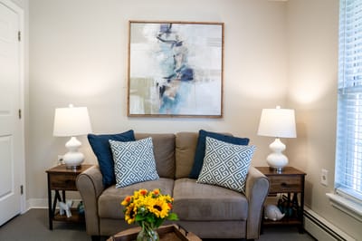 Cozy lounge area with decorative pillows and a floral centerpiece