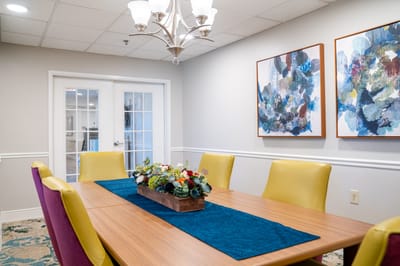 Interior dining area with a table and colorful chairs