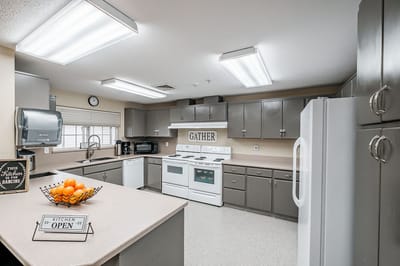 A bright kitchen space with a gathering area