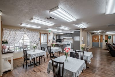 Bright dining room with tables and flower centerpieces