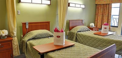 Twin resident rooms with beds and decorations