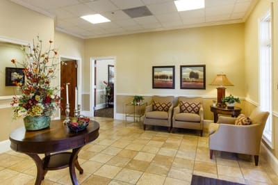 Interior lobby with seating and decorative flowers