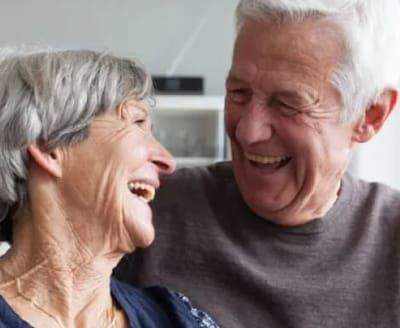 Happy older couple laughing together indoors