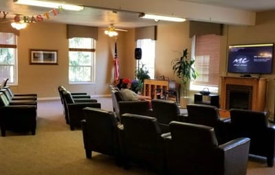 Residents relaxing in a common area with comfortable seating