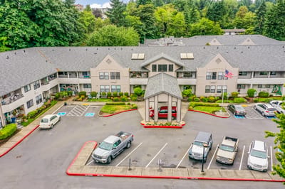 Exterior view of assisted living facility with parking area