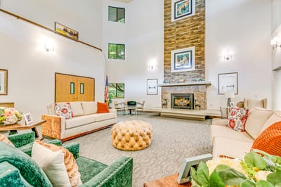 Bright common area with seating and fireplace