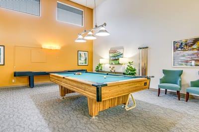 Interior game room with a pool table and seating