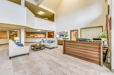 Bright lobby area with reception desk and seating