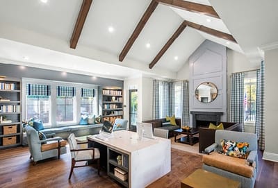 Bright common area with comfortable seating and shelves of books
