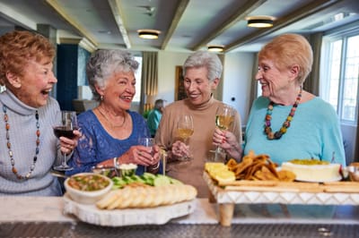 Residents enjoying a celebration with food and drinks