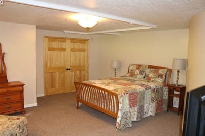 Cozy private room with a bed and wooden furniture