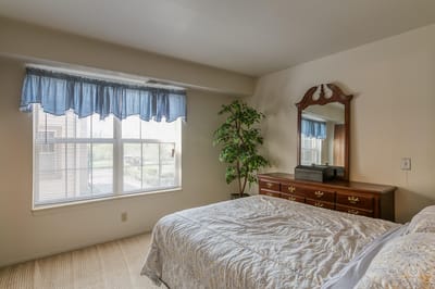 Cozy bedroom with dresser and large window