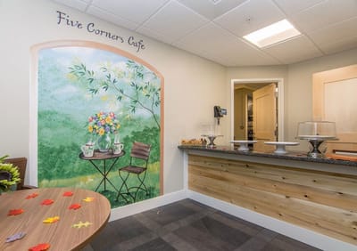 Interior of Five Corners Café with mural and seating