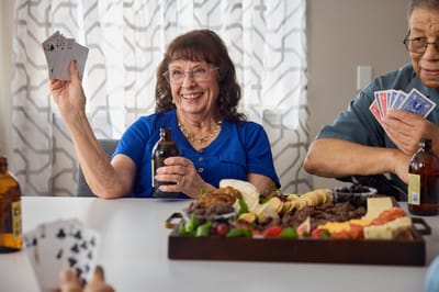 Residents enjoying a card game with snacks