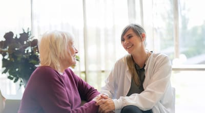 A caregiver and a resident engaging in conversation