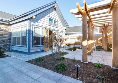 Exterior view of a modern assisted living building with landscaping