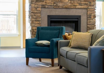 Cozy seating area near a stone fireplace