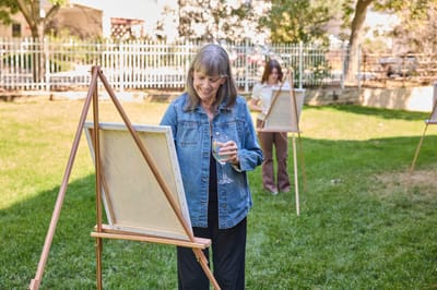 Residents participating in an outdoor painting activity