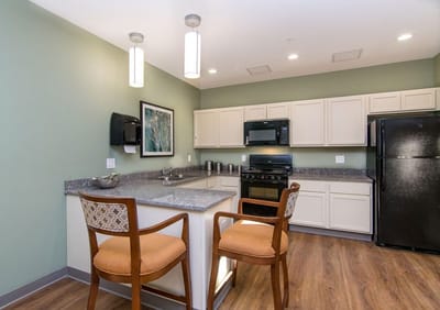 Modern kitchen area with seating and appliances